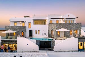 a house with a swimming pool in front of it at Santorini Secret Premium in Oia