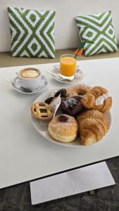 a plate of pastries on a table with a cup of coffee at Fortino Capri in Capri