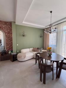 a living room with a couch and a table at Utopia House & Garage in Kavála