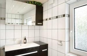 a bathroom with a sink and a mirror at Seelina in Perach +4 photos