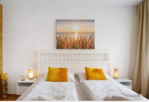 a bedroom with two beds with yellow pillows at Seelina in Perach