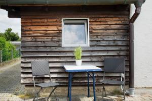 a table and two chairs in front of a building at Seelina in Perach