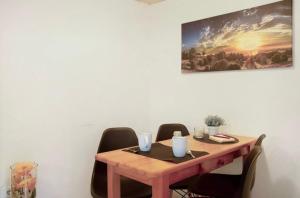 a wooden table with chairs in a room with a painting at Seelina in Perach