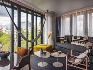 a living room with a couch and a table at Novotel Paris Porte Versailles in Paris
