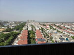 a view of a city from a balcony at Siri Stays in Greater Noida