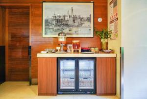 a kitchen with a drink cooler in a room at Radisson Collection Hyland Shanghai in Shanghai