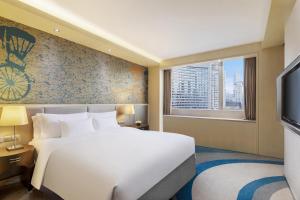 a bedroom with a large white bed and a window at Radisson Collection Hyland Shanghai in Shanghai +126 photos