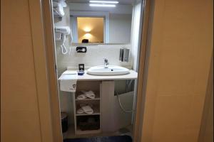 a bathroom with a sink and a mirror at Lighthouse Taranto in Taranto +8 photos