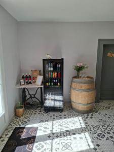 a room with a wine cooler and a barrel at Les Marchettes in Saint-Nexans