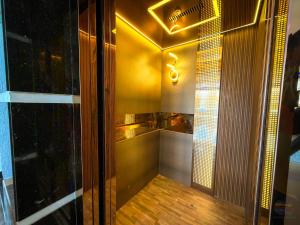 a bathroom with a shower with a wooden floor at Hotel Shanti Residency Vrindavan in Vrindāvan
