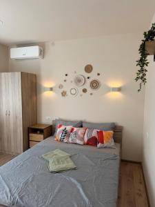 a bedroom with a bed with two pillows on it at Boho style house Varna in Varna City