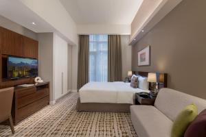 a hotel room with a bed and a couch at Citadines Salcedo Makati in Manila +25 photos