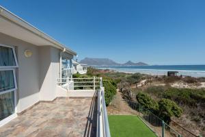 a balcony with a view of the beach at Woodbridge Lodge in Cape Town