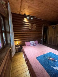 a bedroom with a bed in a wooden cabin at Tre Vibe Resort Daklak in Buôn Jung +43 photos