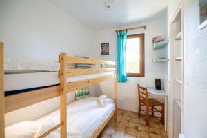 a bedroom with two bunk beds and a desk at House with small garden and shared pool in Moliets-et-Maa