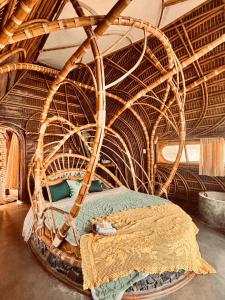 a bedroom with a large wicker bed in a room at Tre Vibe Resort Daklak in Buôn Jung
