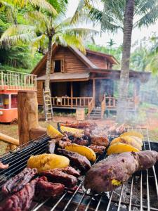 a grill with many different types of meat on it at Tre Vibe Resort Daklak in Buôn Jung