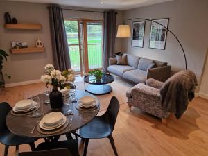 a living room with a table and a couch at Halton Hideaway in Halton +11 photos
