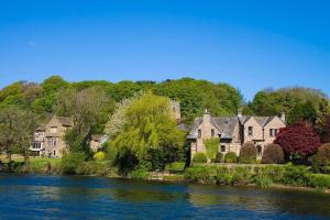 a group of houses on the shore of a river at Halton Hideaway in Halton