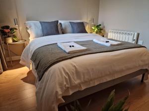 a bedroom with a large bed with towels on it at Halton Hideaway in Halton
