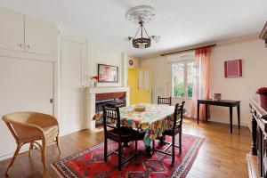 a dining room with a table and chairs and a fireplace at Gîte La Bonnetière in Joué-lès-Tours +18 photos