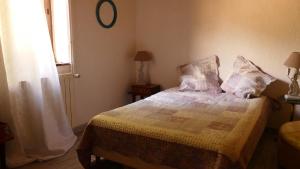 a bedroom with a bed with pillows and a window at "La Résistance" proche du Pal in Loddes