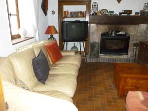 a living room with a white couch and a fireplace at "La Résistance" proche du Pal in Loddes