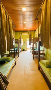 a room with several bunk beds in a house at Hangten's Surf Skate Hostel in Arugam Bay +17 photos