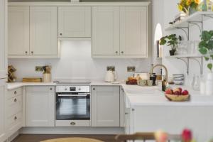 a white kitchen with white cabinets and an oven at 20 Applegrove in Monifieth