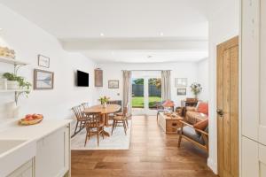 a kitchen and living room with a table and chairs at 20 Applegrove in Monifieth +24 photos