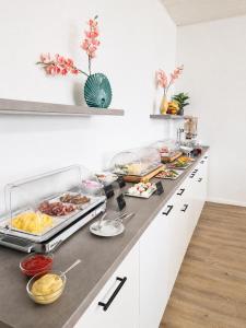 a buffet with many different foods on a counter at Pension Haus Weierts in Norderney