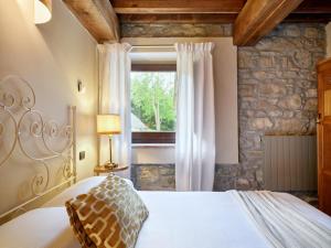 a bedroom with a bed and a window at Tenuta Valdea in Firenzuola