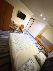 a view of a room with a bed and a tv at Evim Butik Otel in Seyhan