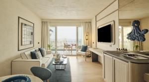 a living room with a couch and a table at Mazzarò Sea Palace - The Leading Hotels of the World in Taormina