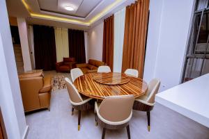 a dining room with a table and chairs at The Moon Apartment in Kigali