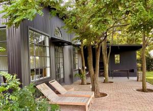 a patio with two benches in front of a building at Field Cabin in Rosendal