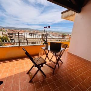 a balcony with a table and a laptop on it at Aura Apartment in Senorbì