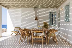 a dining room with a table and chairs at Acron Vigla in Mikri Vigla