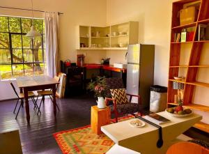 a kitchen and living room with a table and a refrigerator at Field Cabin in Rosendal