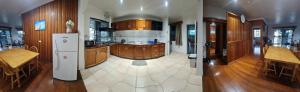 a large kitchen with wooden cabinets and a refrigerator at Spacious 4-bdrm fully self-contained WIFI, Parking in Suva