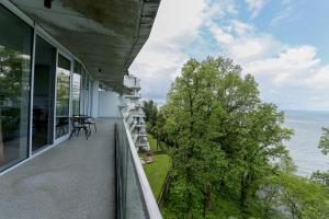 a balcony of a house with a view of the water at Green Cape Botanico in Batumi