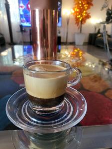 a glass cup of coffee on a table with a drink at Noble Villa in Abidjan
