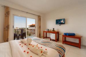 a bedroom with a bed with a view of a balcony at Malika Blue Hotel Nungwi, Zanzibar in Banda Kuu +68 photos