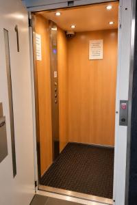 a hallway with a door with a sign on it at Belmercer Motel in Geelong