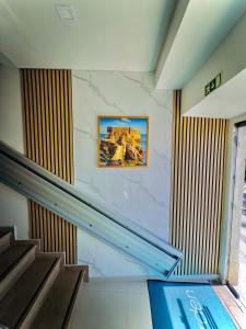 a staircase in a building with a picture on the wall at Sea Garden Peniche in Peniche +51 photos