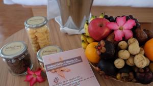 a table topped with a basket of fruits and nuts at Marahai Villa Morotai in Dehegila