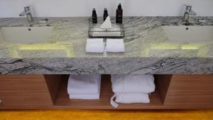 a bathroom with two sinks and two towels at Marahai Villa Morotai in Dehegila +42 photos