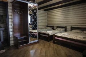 a room with two beds and a mirror at Сонячна in Solotvyno +67 photos