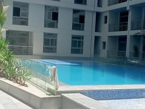 a swimming pool in front of a building at رويال جاردن سويت in Cairo
