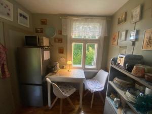 a small kitchen with a table and a window at Bezvējš in Jūrmala